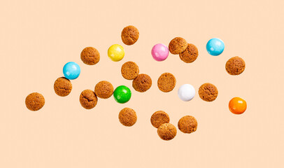 Dutch holiday Sinterklaas greetings card with flying kruidnoten cookies. Pepernoten, traditional sweets, strooigoed. Levitation concept of Saint Nicholas day with copy space.