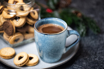 Rustic ceramic mug with a hot chocolate cocoa drink with marshmallows. Christmas homemade gingerbread cookies