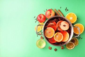 Concept of cooking  mulled wine on green background