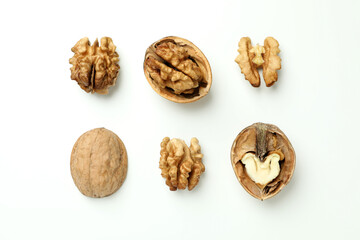 Walnuts with nutshell on white background, top view