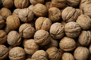 Walnuts in nutshell all over background, top view