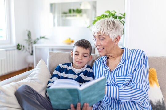 Loving Grandmother Teaching Grandson Holding Book Sitting On Sofa, Grandma Baby Sitter Embracing Kid Boy Reading Fairytale To Cute Child, Nanny Granny Telling Story To Preschool Grandchild