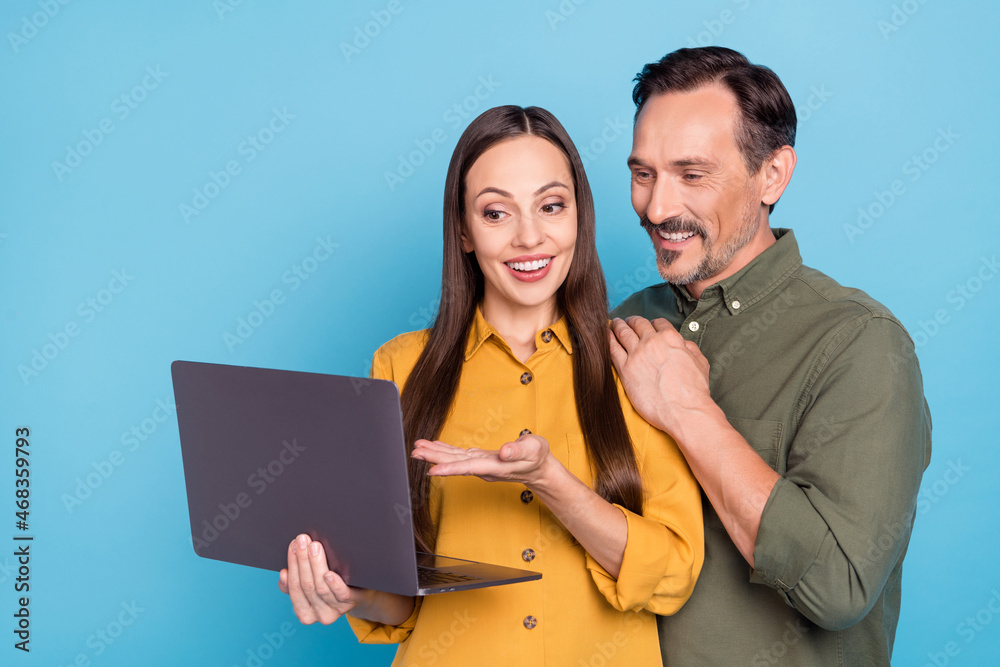 Wall mural Portrait of attractive lady handsome man look show netbook hand touch shoulder isolated on blue color background