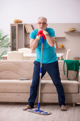 Old man cleaning the house