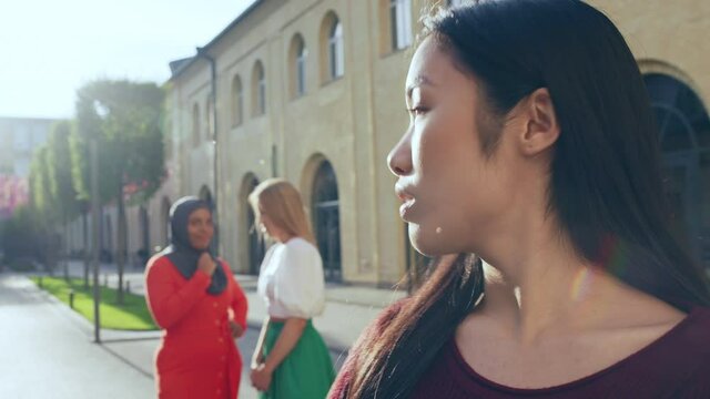 Asian female suffering from gossips, racial discrimination, cultural prejudice