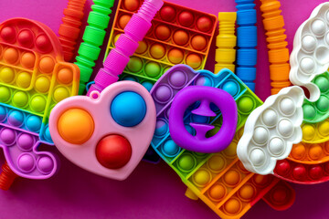 Antistress toys education concept. Popular toy among children. Pink background.