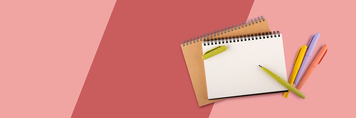 Blank note book paper and color pen on colorful background, flat lay.
