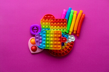 Antistress toys education concept. Popular toy among children. Pink background.