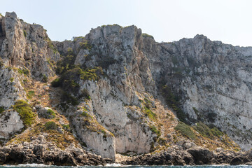 Limestone rocks, vegetation and the coast of the island of San Domino of the archipelago of the Tremiti Islands in Puglia, Italy.