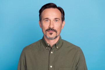 Photo of mature happy handsome man wear casual green shirt good mood isolated on pastel blue color...