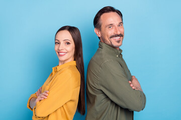 Profile side photo of cheerful happy mature man and woman hold hands folded enjoy isolated on blue color background