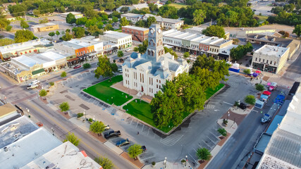 Aerial view historic Hood County Courthouse and Clock Tower in downtown Square Granbury, Texas, USA