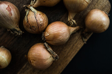 Raw yellow onion on the black background, Onion flat lay, vegetarian fresh, close up photo 