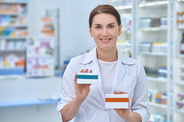 Woman pharmacist with medicines in hands