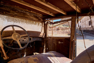 Old car with rust abandoned on the street