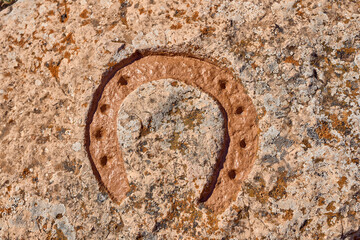 Horseshoe engraved on a stone