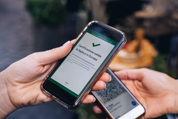 Checking vaccination certificate or negative test for covid-2019 Green Pass at the entrance to a restaurant in Italy