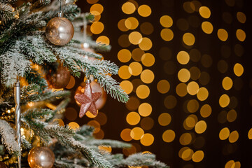 Modern design Christmas tree decorated with balls, toys and garlands - blue, brown, beige, pink, gold colors. Winter holidays composition.