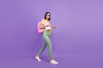 Fototapeta na wymiar Full size profile side photo of young girl go university use smartphone courses academic isolated over purple color background
