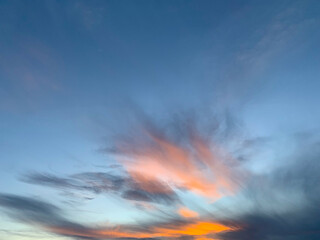 Fototapeta na wymiar small orange clouds in the blue sky background