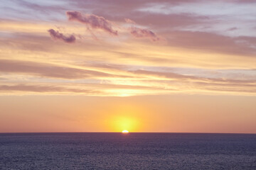 Naklejka na ściany i meble Beautiful sunset, disappearing sun on the horizon line.
