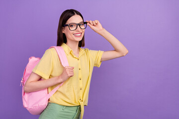 Profile side photo of young school girl eyewear smart rucksack courses isolated over violet color background