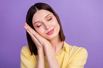 Photo of youth adorable girl hands touch cheek relax asleep isolated over violet color background