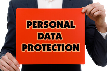 A businessman shows an inscription: PERSONAL DATA PROTECTION