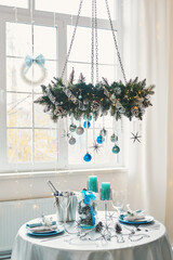 Christmas table. Blue and white decor christmas tree background. New Year celebration. Merry Christmas and Happy New Year.