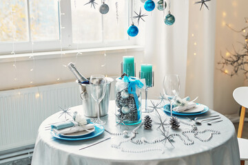 Christmas table. Blue and white decor christmas tree background. New Year celebration. Merry Christmas and Happy New Year.