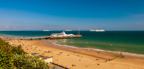 Bournemouth beach and pier with cruise liners moored in Poole Bay