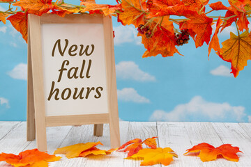 New fall hours sign with standing whiteboard with fall leaves