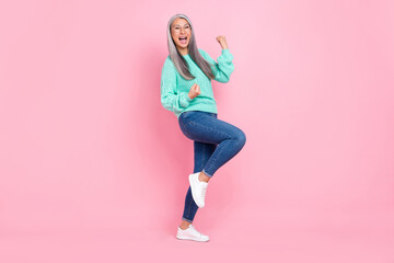 Fototapeta na wymiar Photo of cool white hairdo old lady yell wear eyewear teal pullover jeans sneakers isolated on pink color background