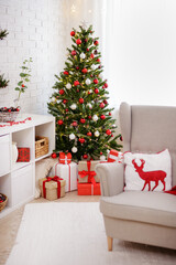 living room with armchair and christmas tree