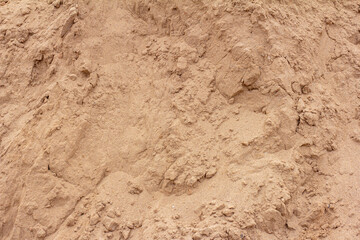 Sandy background, texture of dry sand with lumps.
