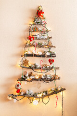 Christmas tree made of dry branches with ligths and ornaments