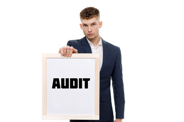 A businessman shows an inscription: AUDIT