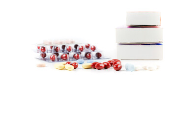 Variety of different pills and capsules on white table