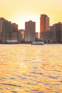 Vivid sunset over NJ skyline captured from lover Manhattan peers.