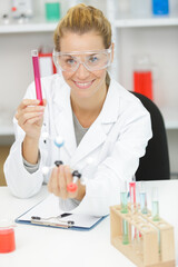 happy female worker test tube