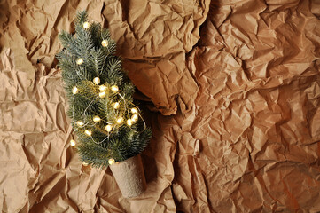 Recycled paper background. Artificial Christmas tree. Sustainability in preparation for Christmas