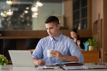 smiling businessman having virtual team meeting call, talking, remotely working at home watching online learning training webinar in remote office