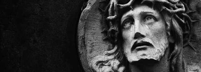 Jesus Christ in a crown of thorns. Tears on his face as symbol of pain, death and resurection....
