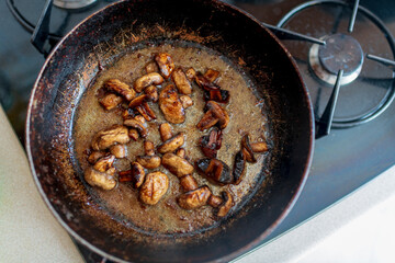 beautiful fried mushrooms champignon in background cast iron pan