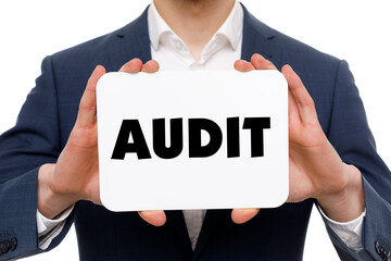 A businessman shows an inscription: AUDIT