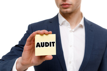 A businessman shows an inscription: AUDIT