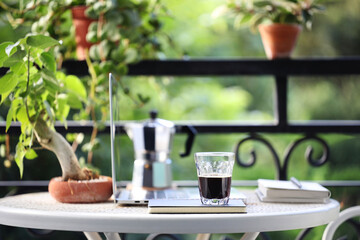 coffee glass cup and moka pot and laptop on metal table