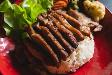 Thai style grilled pork with rice and vegetable, meal meat for dinner or lunch main dishes