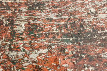 Old red paint with scratches on the wall. Background texture