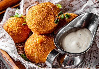 Fried Mozzarella Cheese Balls with Sauce on dark wooden background